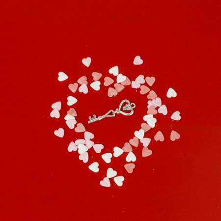 Heart shaped key on red background, valentine's day conceptの写真素材