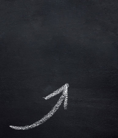 Chalk drawing of an arrow on a blackboard. Business conceptの写真素材