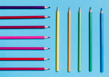 Colored pencils on a blue background. Flat lay, top view.の写真素材