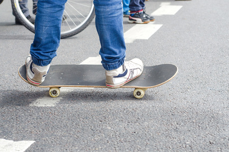 Feet On Skateboard. Close up of feet on a skateboardの写真素材