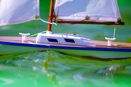 Traditional small wooden sailing boat in the pond of parkの写真素材