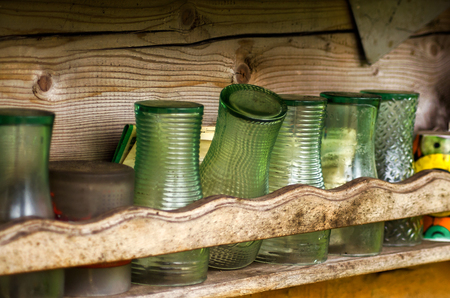 Row of old glasses on the wooden shelfの写真素材