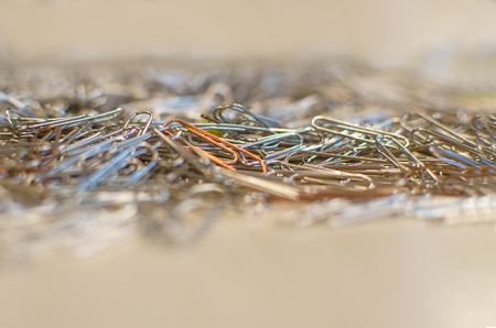 Many steel paper clips yellowy backgroundの写真素材
