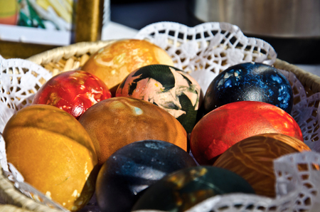 Brightly colored Easter eggs in a basketの写真素材