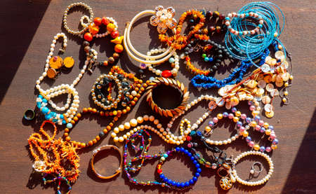 a lot of costume jewelry with different materials on a black background in. High quality photoの写真素材