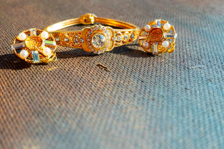 Set of a luxury elegant bracelet and earrings on a dark background. High quality photoの写真素材