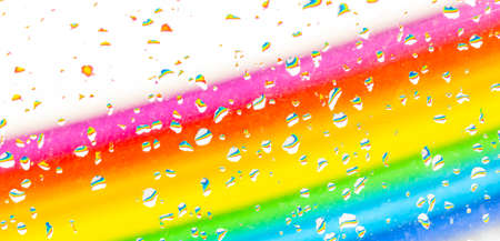 abstract colorful diagonal rainbow background with water drops on a glass with bubblesの写真素材