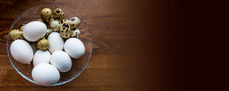background of quail spotted and chicken white eggs in a saucepan. Quail eggs on white dish, There...