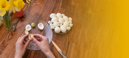 step by step. egg cut in half, for making stuffed eggs. womens hands cut eggs in half and take out...
