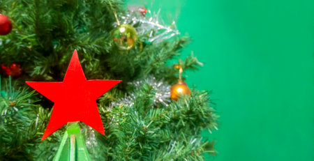 Christmas and New years eve Background. a Christmas tree decorated with a red Soviet five-pointed red star. Panoramic classic header Web banner with copy space for design. High quality photoの写真素材