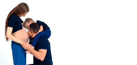 beautiful european happy family with a pregnant mother, the father and a son together. High quality...