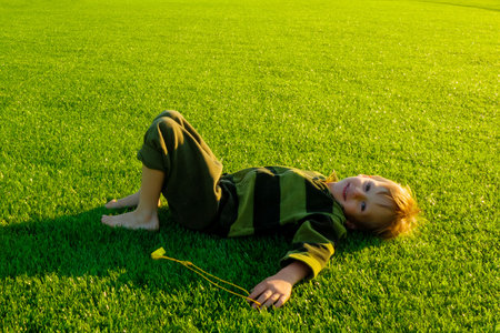 The child is lying on the grass. High quality photoの写真素材