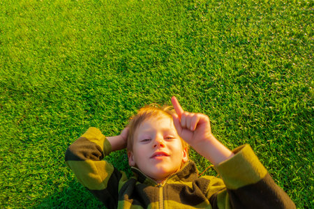 The child goes in for sports at the stadium. The boy training before playing football. banner with copy spaceの写真素材