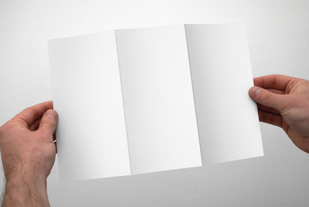 DL Tri-Fold Brochure with Handの写真素材