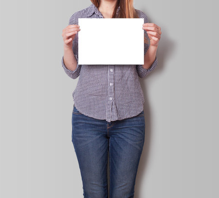 A Woman Holding an Empty Poster Mockupの写真素材