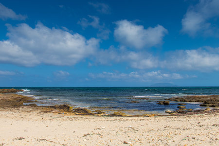 Deserted Wild Beach with Mountains and Sea in Tunisia, North Africaの写真素材