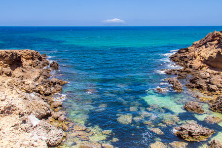 Deserted Wild Beach with Mountains and Sea in Tunisia, North Africaの写真素材
