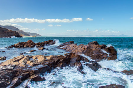 Deserted Haven: Ain Kanassira's Beach Nestled Between Sea and Mountains in Tunisia.の写真素材