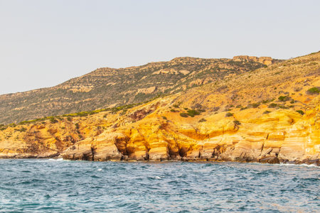 Deserted Haven: Ain Kanassira's Beach Nestled Between Sea and Mountains in Tunisia.の写真素材