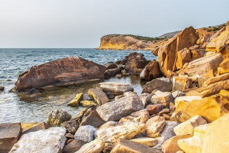 Deserted Haven: Ain Kanassira's Beach Nestled Between Sea and Mountains in Tunisia.の写真素材