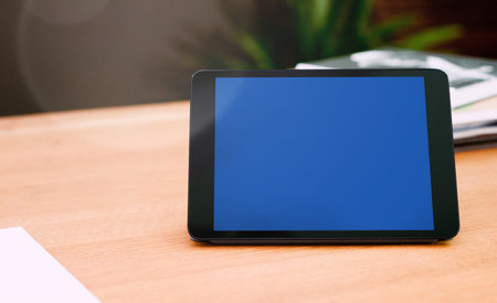 Tablet with blank screen mockup on tableの写真素材