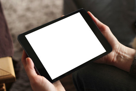 Hand holding tablet with blank screenの写真素材