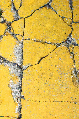 Close up of yellow pavement texture, with vibrant colors for creativity, imaginative backgrounds and ideas. Suitable for print, web, cards, posters, flyers.の写真素材