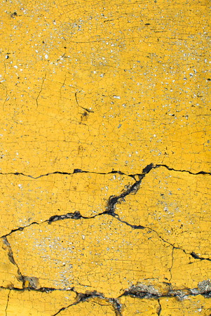 Close up of yellow pavement texture, with vibrant colors for creativity, imaginative backgrounds and ideas. Suitable for print, web, cards, posters, flyers.の写真素材