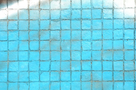 Painted mosaic brick tile wall, close up of graffiti texture, with vibrant colors for creativity, imaginative backgrounds and ideas.の写真素材