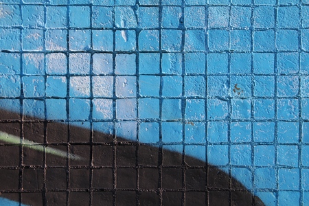 Painted mosaic brick tile wall, close up of graffiti texture, with vibrant colors for creativity, imaginative backgrounds and ideas.の写真素材