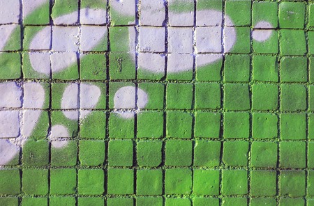 Painted mosaic brick tile wall, close up of graffiti texture, with vibrant colors for creativity,...