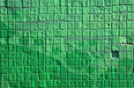 Painted mosaic brick tile wall, close up of graffiti texture, with vibrant colors for creativity, imaginative backgrounds and ideas.の写真素材