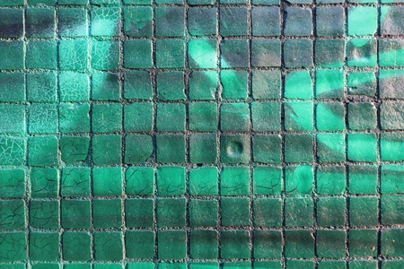 Painted mosaic brick tile wall, close up of graffiti texture, with vibrant colors for creativity, imaginative backgrounds and ideas.の写真素材