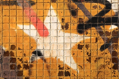 Painted mosaic brick tile wall, close up of graffiti texture, with vibrant colors for creativity, imaginative backgrounds and ideas.の写真素材