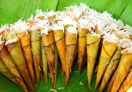 Thai native dessert called   Kanom Kruay   on the banana leaf  Made from banana,powder,sugar and coconut milk の写真素材