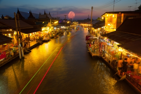SUMUTHSONGKRAM,THAILAND-DECEMBER 30:Beautiful evening with firework background called Ampawa floating market is the famous place to visit in Thailand on December 30,2012 in Samuthsongkram,Thailand のeditorial素材