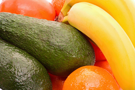 Mix of tangerines, bananas, avocado and kaki close upの写真素材