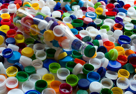 Group of assorted colored plastic cups for recyclingの写真素材