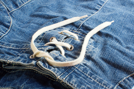 Blue jeans skirt with lacing close upの写真素材