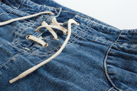Blue jeans skirt with lacing close upの写真素材