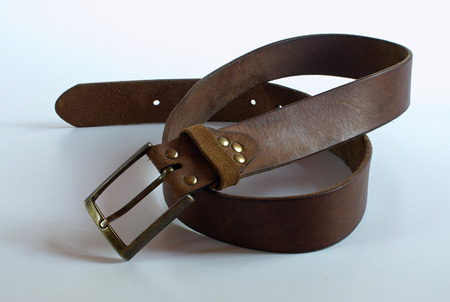 Leather old brown belt on white backgroundの写真素材