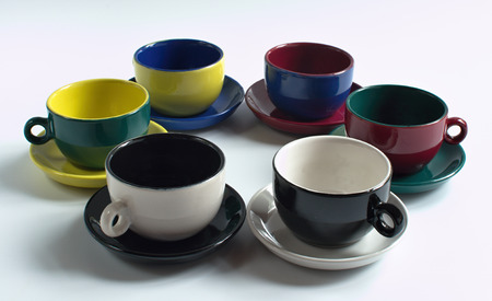 Set of varicolored small cups with saucersの写真素材