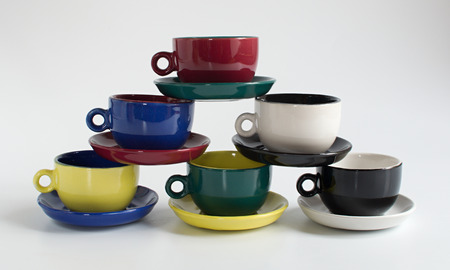 Set of varicolored small cups with saucersの写真素材