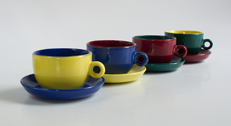 Set of varicolored small cups with saucersの写真素材