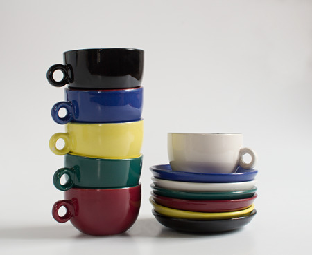 Set of varicolored small cups with saucersの写真素材