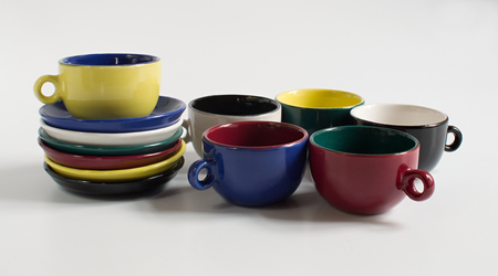 Set of varicolored small cups with saucersの写真素材