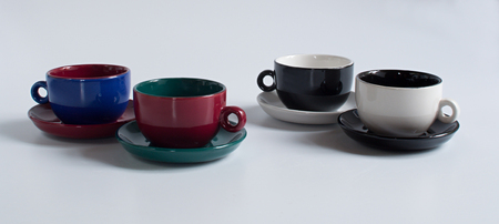 Set of varicolored small cups with saucersの写真素材