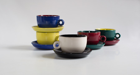 Set of varicolored small cups with saucersの写真素材