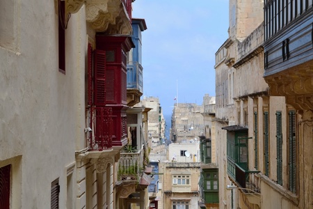 colorful balconies in narrow street in Valletta, Maltaの写真素材