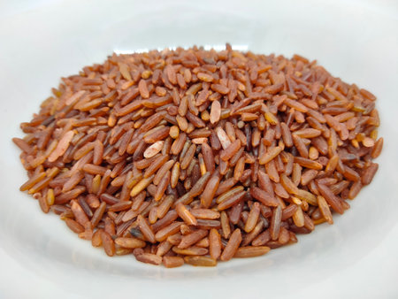 Heap of organic red rice isolated on white background. High angle view.の写真素材